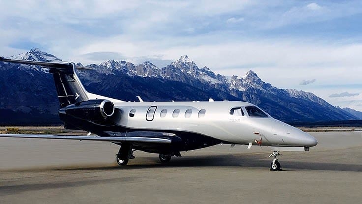 A small jet plane sitting on top of an airport runway.